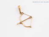a gold bow and arrow pendant on a white background