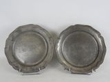 pair of silverplated dishes on stands on a white surface