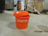 an orange bucket sitting on the floor in a warehouse
