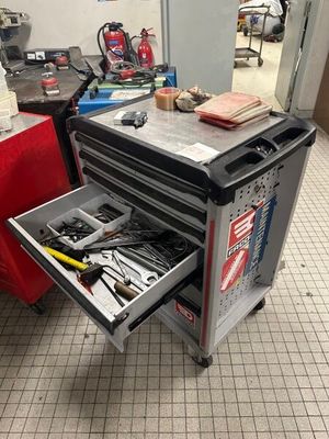 un chariot à outils contenant des outils, dans un garage