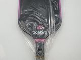 a close up of a tennis racket wrapped in plastic on a table