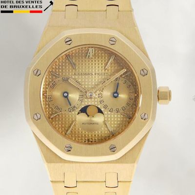 an image of a gold watch with a moon dial on a gold bracelet