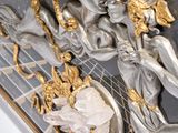 a silver and gold sculpture of a woman riding a horse
