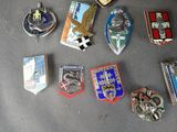 a lot of badges that are on a table