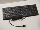 a black keyboard and mouse sitting on a white table