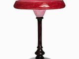 a glass table with a red top and a black base