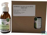 an image of a bottle of liquid next to a cardboard box