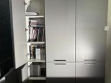 an image of a room with a desk and a bookcase