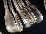 a lot of silver spoons and forks on a table