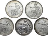 quatre types différents de pièces d'argent sur fond blanc