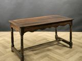 an old wooden table sitting on top of a hard wood floor