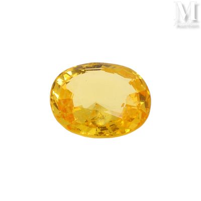 a yellow sapphire stone on a white background