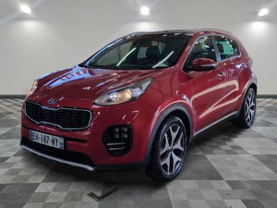 une voiture rouge garée dans un garage au sol en damier
