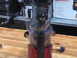 a red blender sitting on a wooden counter