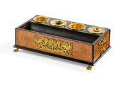 a wooden box that has a gold plate on it