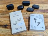 a box of true wireless earbuds and a box of true wireless earbuds on a wooden table