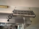 a fan that is hanging from the ceiling in a kitchen