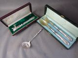 a silverware set in a box with a spoon and a spoon rest