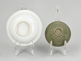 pair of green and white porcelain plates on clear acrylic stands