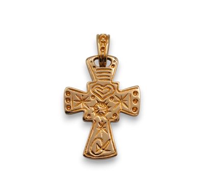 a gold celtic cross pendant on a white background
