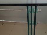 a glass table with a glass top on a tile floor