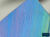 a close up of a piece of metal with a blue and green background
