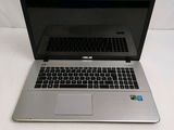 a silver laptop with a black keyboard on a white surface