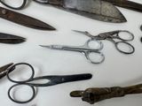 many different types of scissors on a white surface