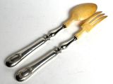 two forks and spoons are sitting on a white surface
