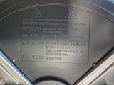 a close up of a parking meter with a warning sign on it