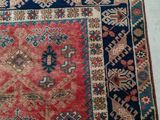 an old rug with a red and blue design on it