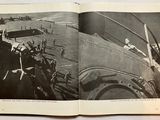 an open book with a black and white photo of a plane