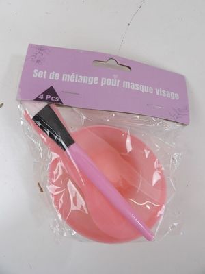 a plastic bowl with a pink brush inside of it