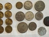 some coins are sitting on a table with a white table cloth