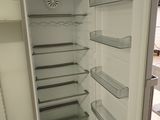 an open refrigerator in a kitchen with no one in it