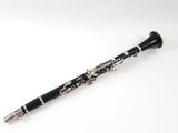 a close up of a clarinet on a white surface