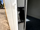 a close up of a door handle on a white trailer