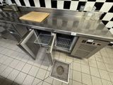 a stainless steel counter top with two open drawers