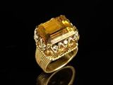 a close up of a gold ring with a citrine stone