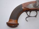 a gun that is on the wall next to a wall