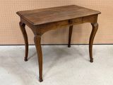 a small wooden table with a drawer on it