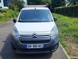 a small white van parked on the side of the road