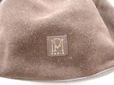 brown bag with a monogram on it sitting on a white surface