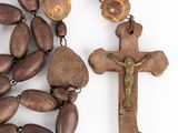 wooden rosary with a crucif and a wooden cross on a white background