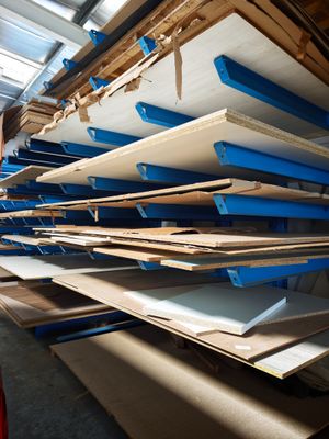 a man that is standing in front of a rack of surfboards