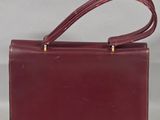 an image of a red leather purse with a long strap