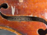 the back of a violin with a label on the back of it