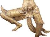 brass statue of a man riding a horse with a bird on its back