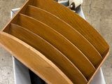 a wooden toilet seat in a box on the floor