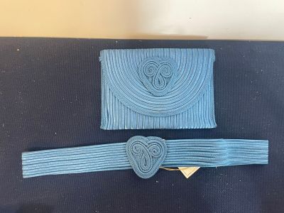 two pieces of blue fabric with a heart on the clasp